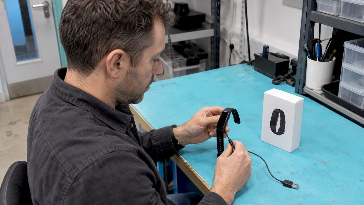 Tester checks tracker beside its carton