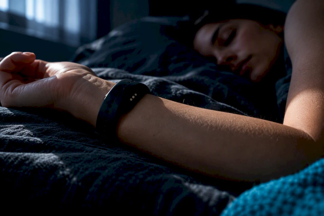 Anonymous wearable sensor beside sleeping adult