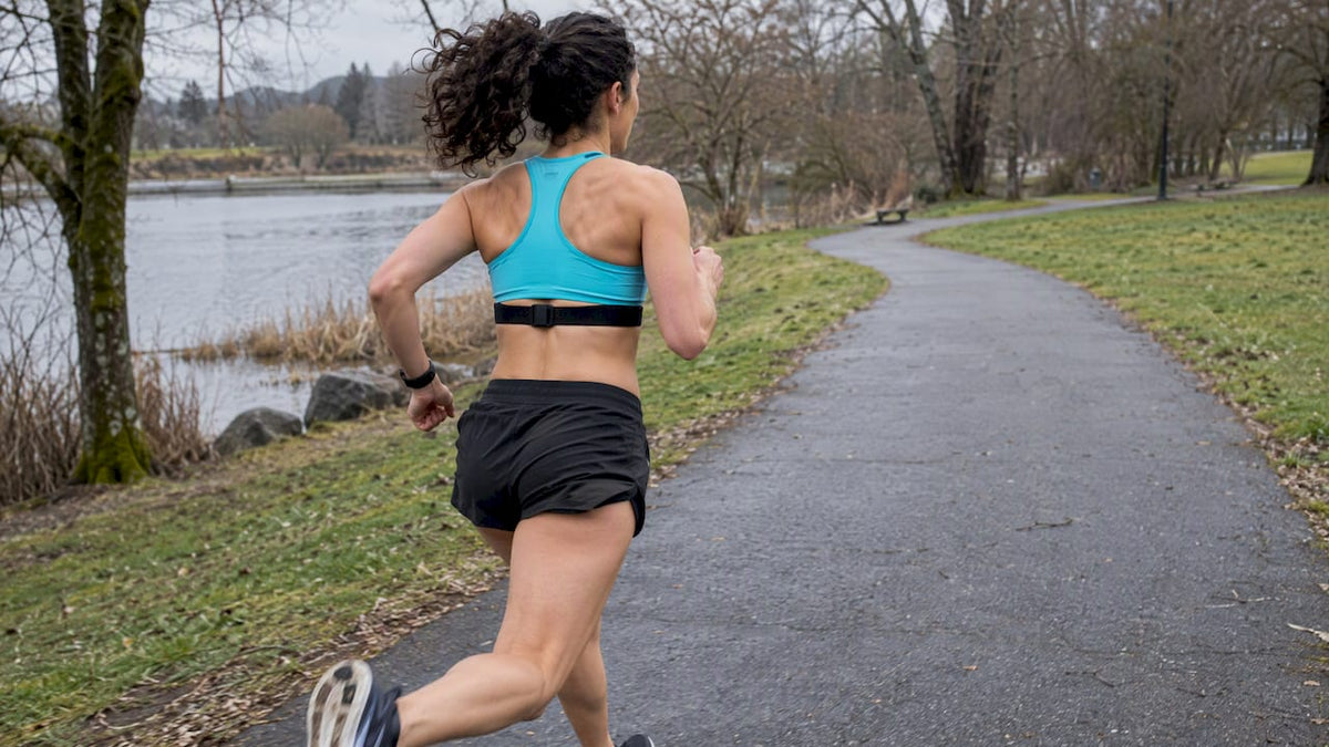 Runner wearing chest strap and wrist monitor